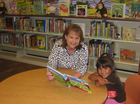 Librarian, Miss Retha reading to little patron, Jackie